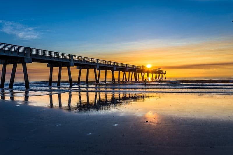 A summer sunrise over a pier in Jacksonville, Florida.