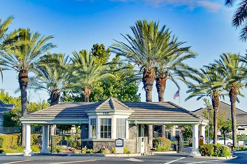 Palm trees beside the gated entrance to Summerset in Brentwood, California.