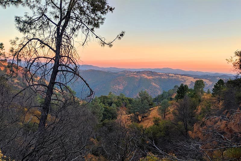 A sunset over the mountainous landscape of Jackson, California.