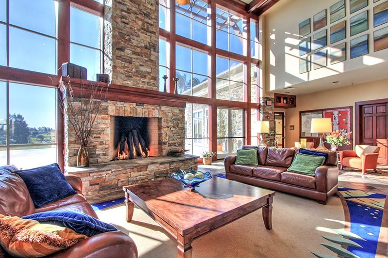 A fireplace in a lounge space at Trilogy at Rio Vista in Rio Vista, California.